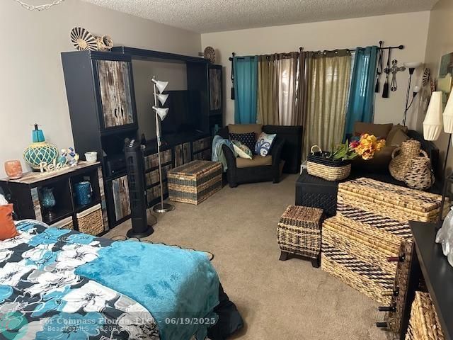 611 South State Road 7, Unit 2E Margate, FL 33068 - Photo 2 of 5 a living room with furniture rug and lamp