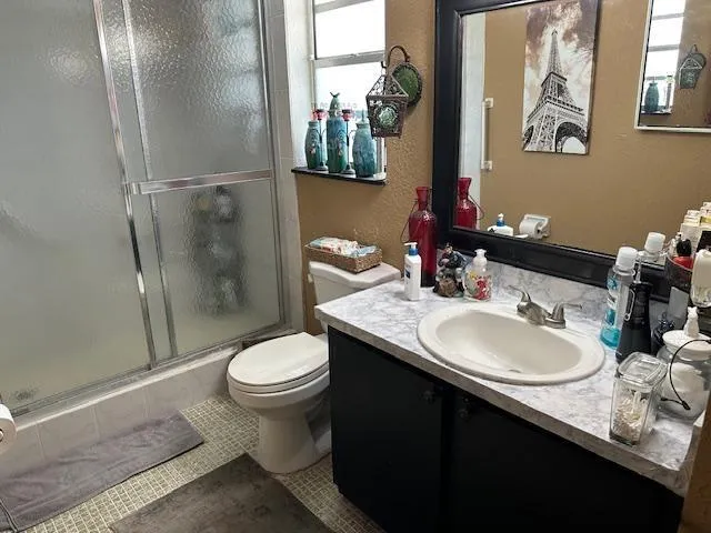 a bathroom with a sink toilet and a mirror