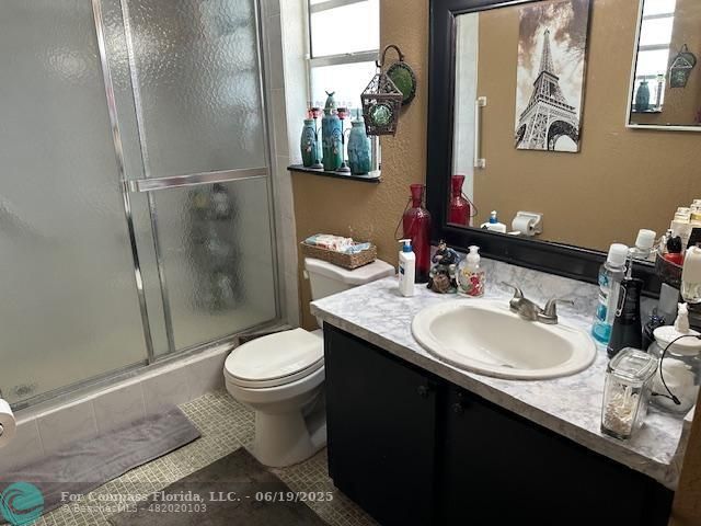 611 South State Road 7, Unit 2E Margate, FL 33068 - Photo 4 of 5 a bathroom with a sink toilet and a mirror
