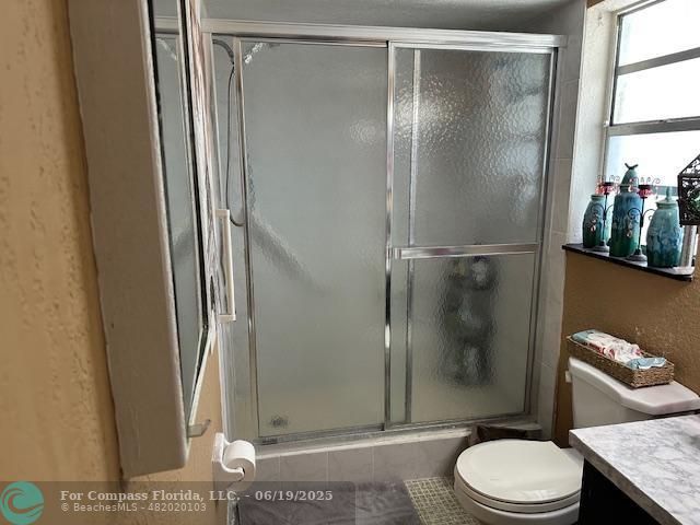 611 South State Road 7, Unit 2E Margate, FL 33068 - Photo 5 of 5 a bathroom with a granite countertop sink toilet and shower