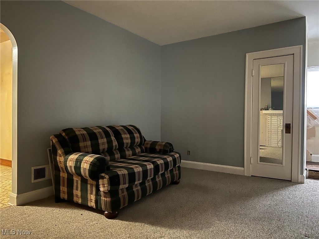 4740 Burleigh Road Cleveland, OH 44125 - Photo 7 of 11 Living area featuring arched doorways and carpet floors