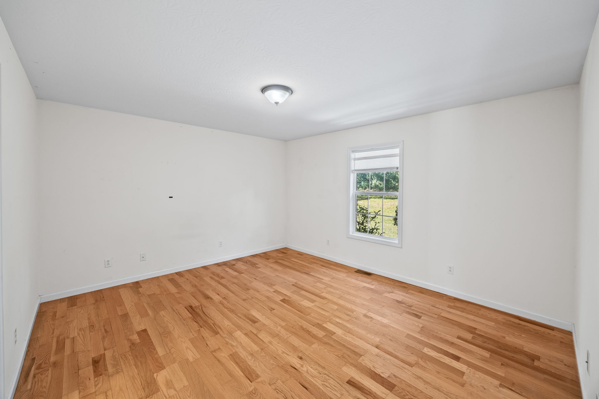 1357 Franklin Loop Clarkrange, TN 38553 - Photo 9 of 37 an empty room with wooden floor and window