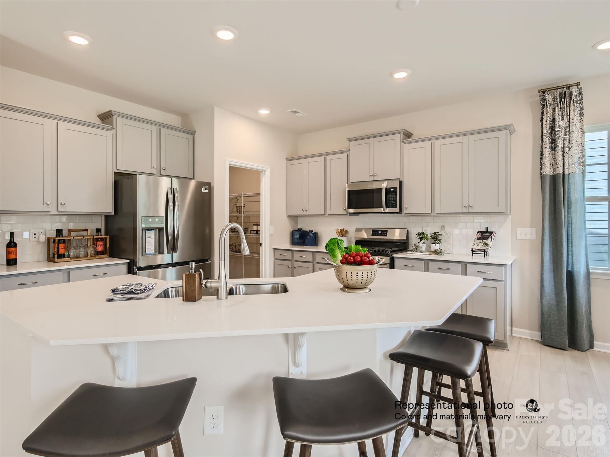 7020 Juneberry Way Maiden, NC 28650 - Photo 2 of 25 a kitchen with stainless steel appliances a refrigerator stove microwave and white cabinets
