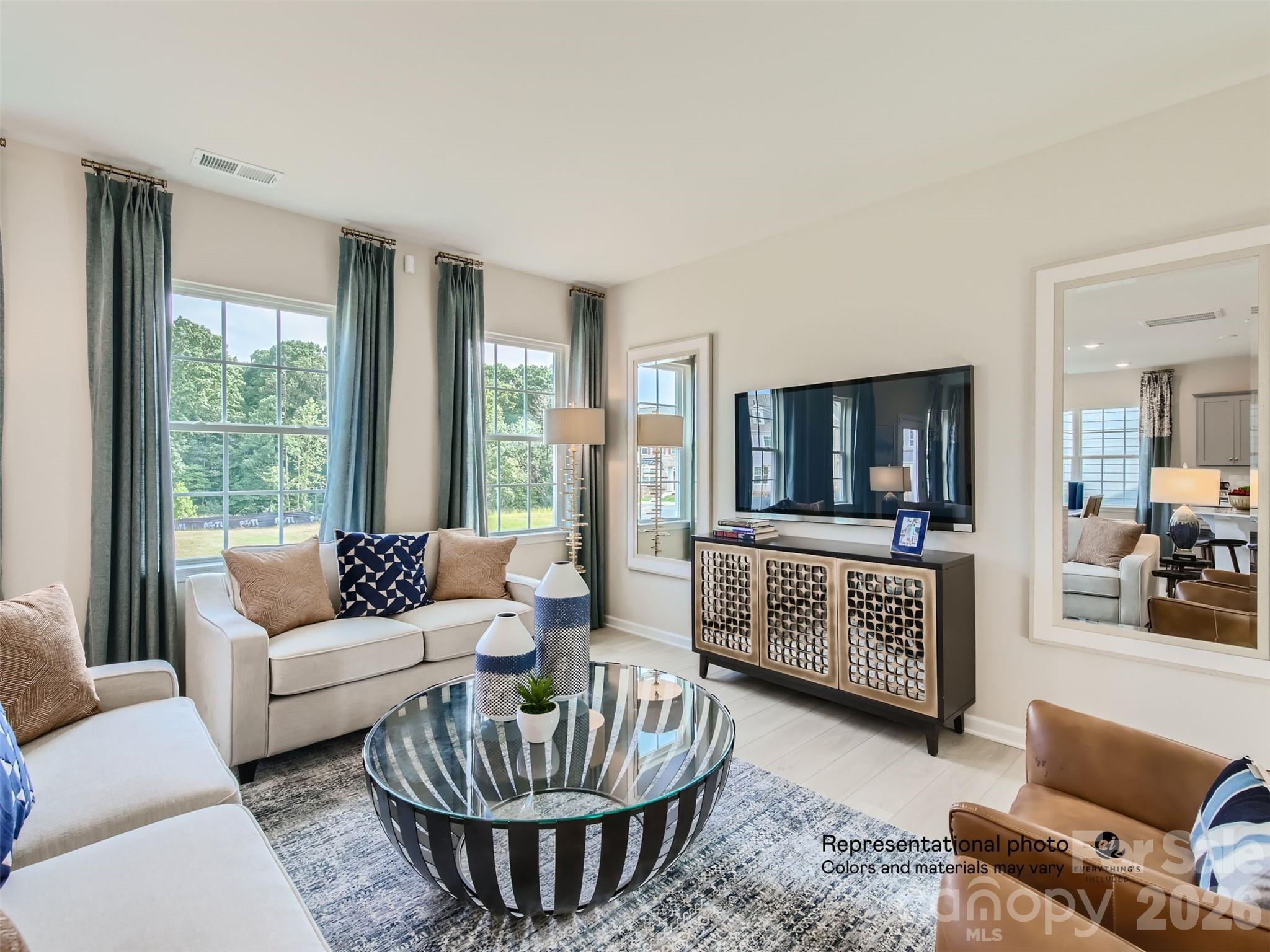 7020 Juneberry Way Maiden, NC 28650 - Photo 5 of 25 a living room with furniture a flat screen tv and a large window