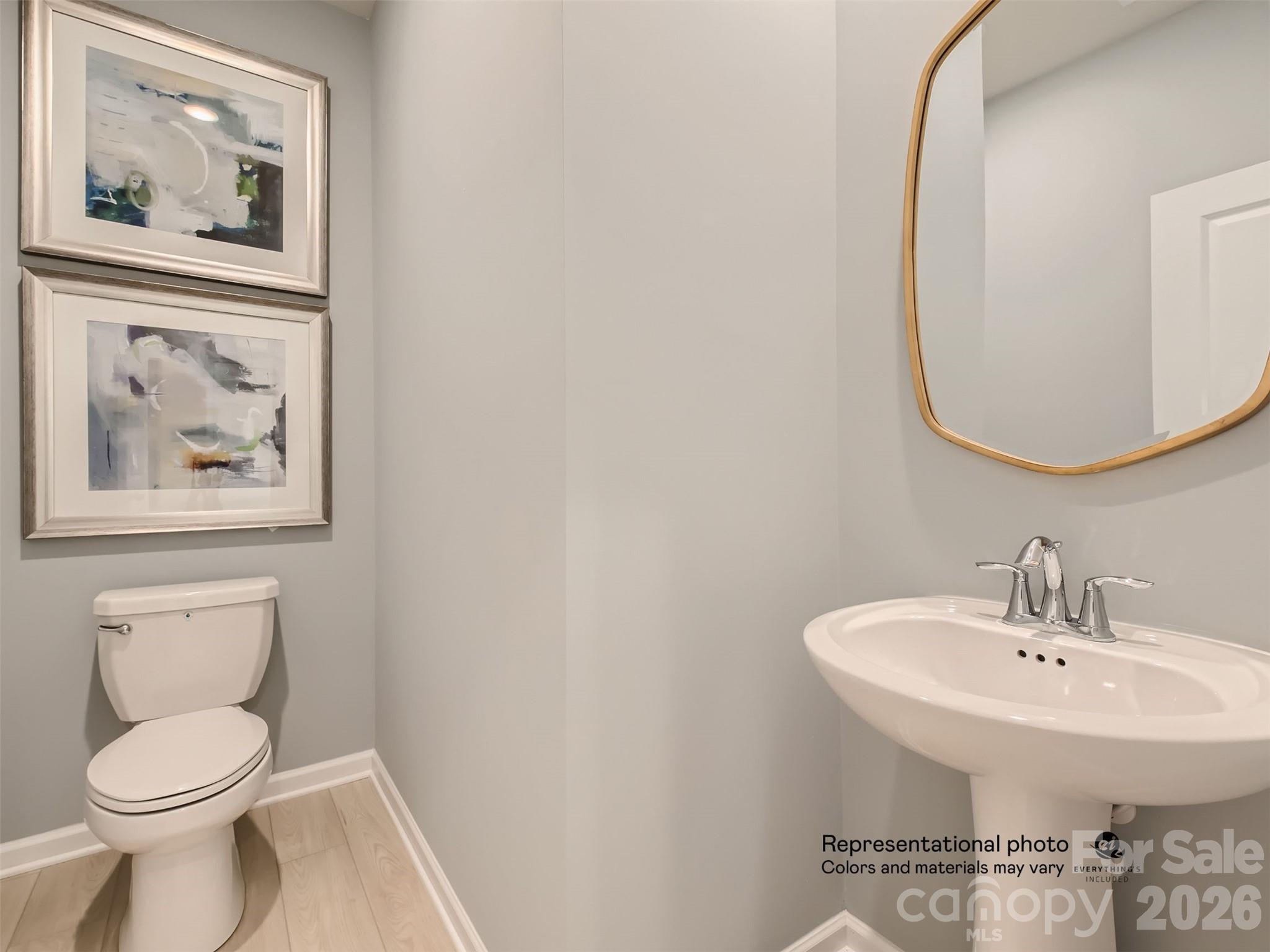 7020 Juneberry Way Maiden, NC 28650 - Photo 9 of 25 a bathroom with a toilet and a sink