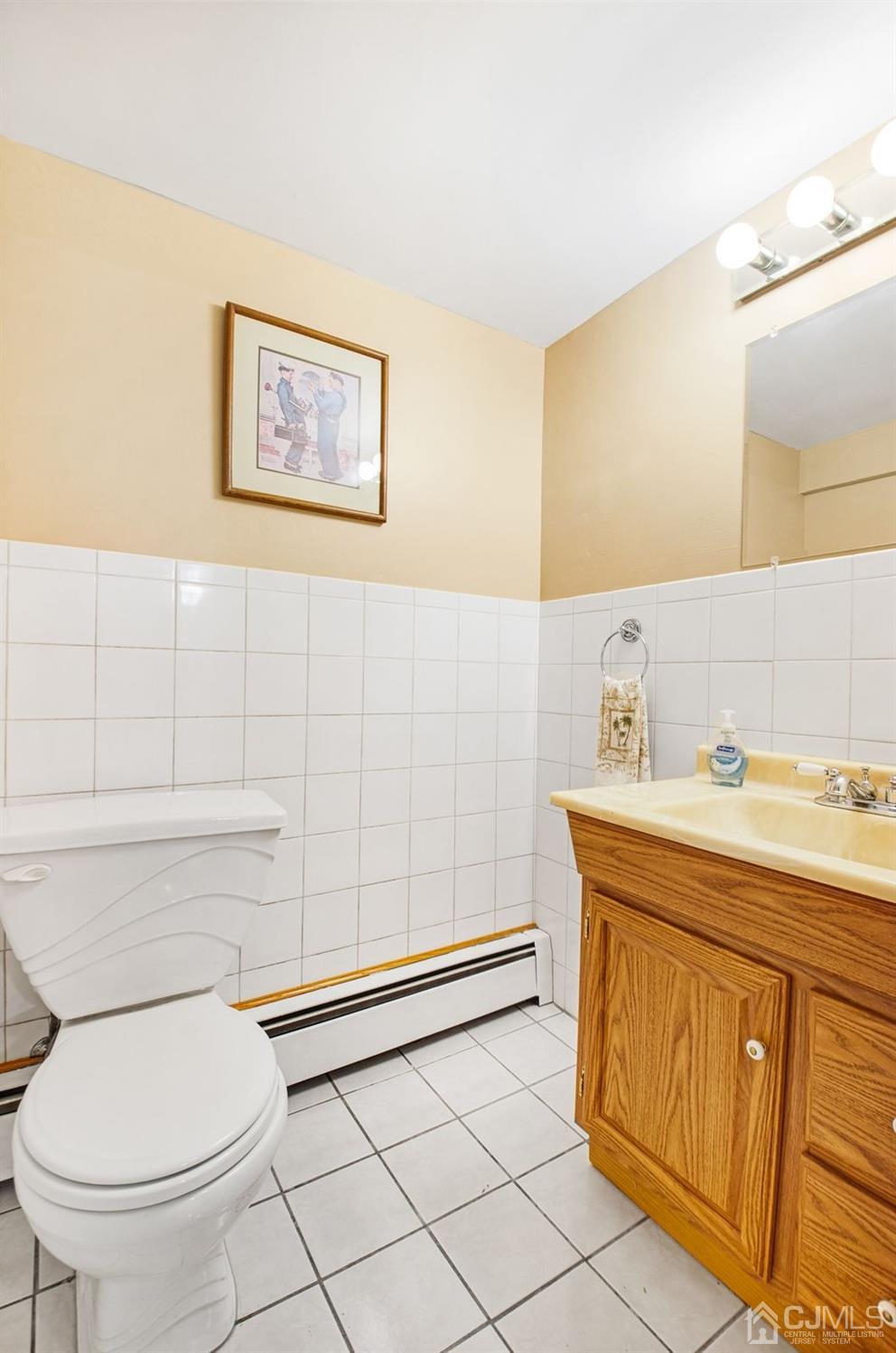 74 Brandywine Road Fords, NJ 08863 - Photo 14 of 16 a bathroom with a toilet a sink and mirror