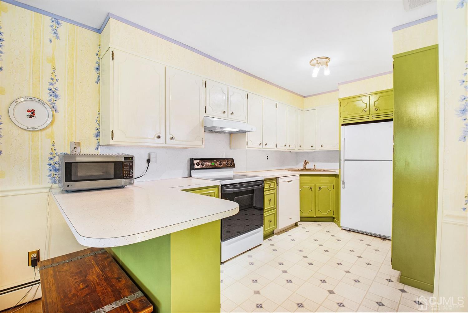 74 Brandywine Road Fords, NJ 08863 - Photo 5 of 16 a kitchen with a refrigerator a stove top oven a sink and cabinets