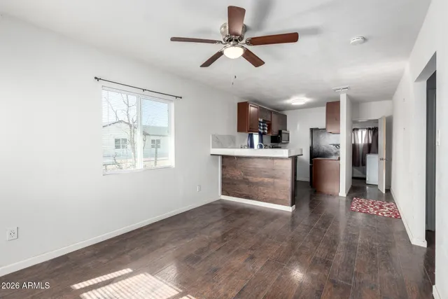 a kitchen with stainless steel appliances kitchen island a refrigerator sink and cabinets