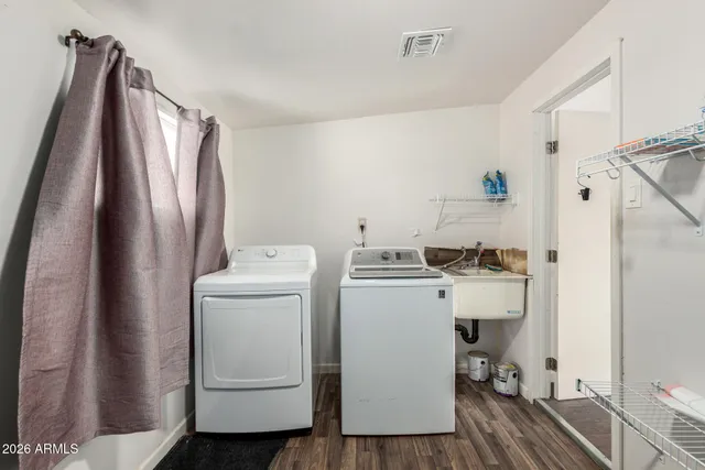 a view of a storage and utility room with washer and dryer