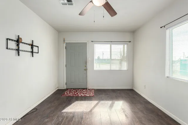 wooden floor in an empty room with a window
