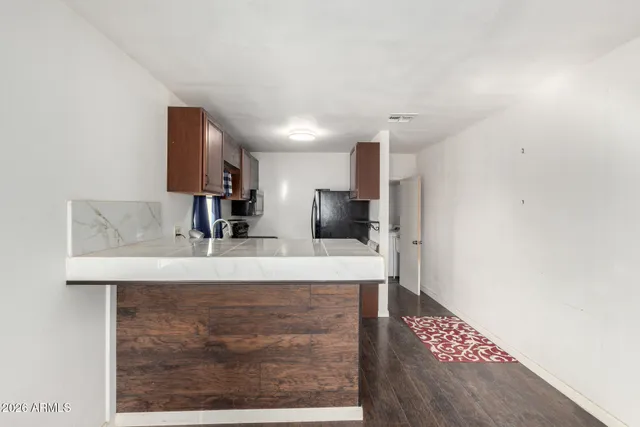 a view of kitchen with sink microwave and refrigerator