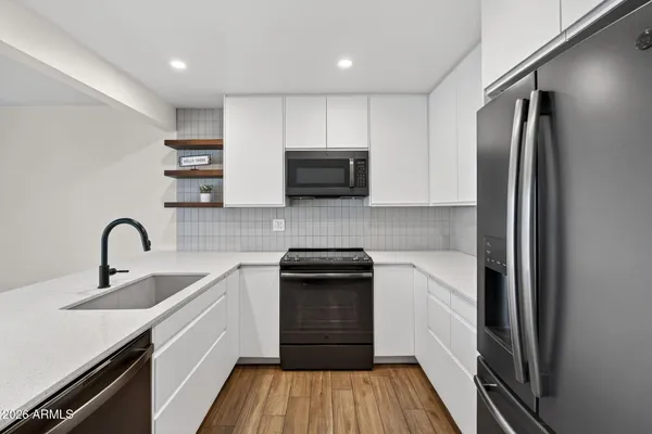 a kitchen with a sink stainless steel appliances and cabinets