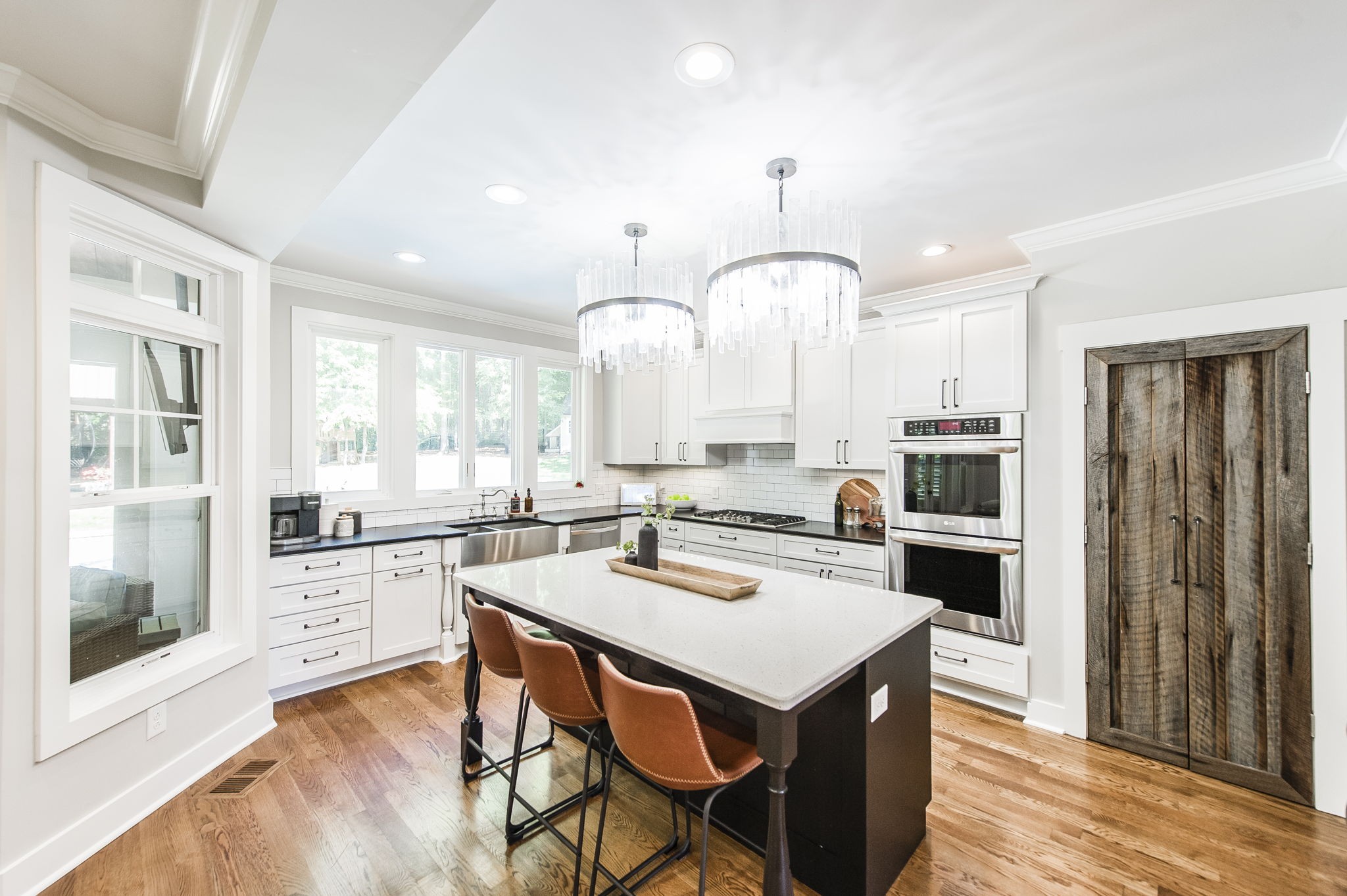 1956 Lake Road Greenbrier, TN 37073 - Photo 14 of 70 a kitchen with a dining table cabinets appliances and wooden floor