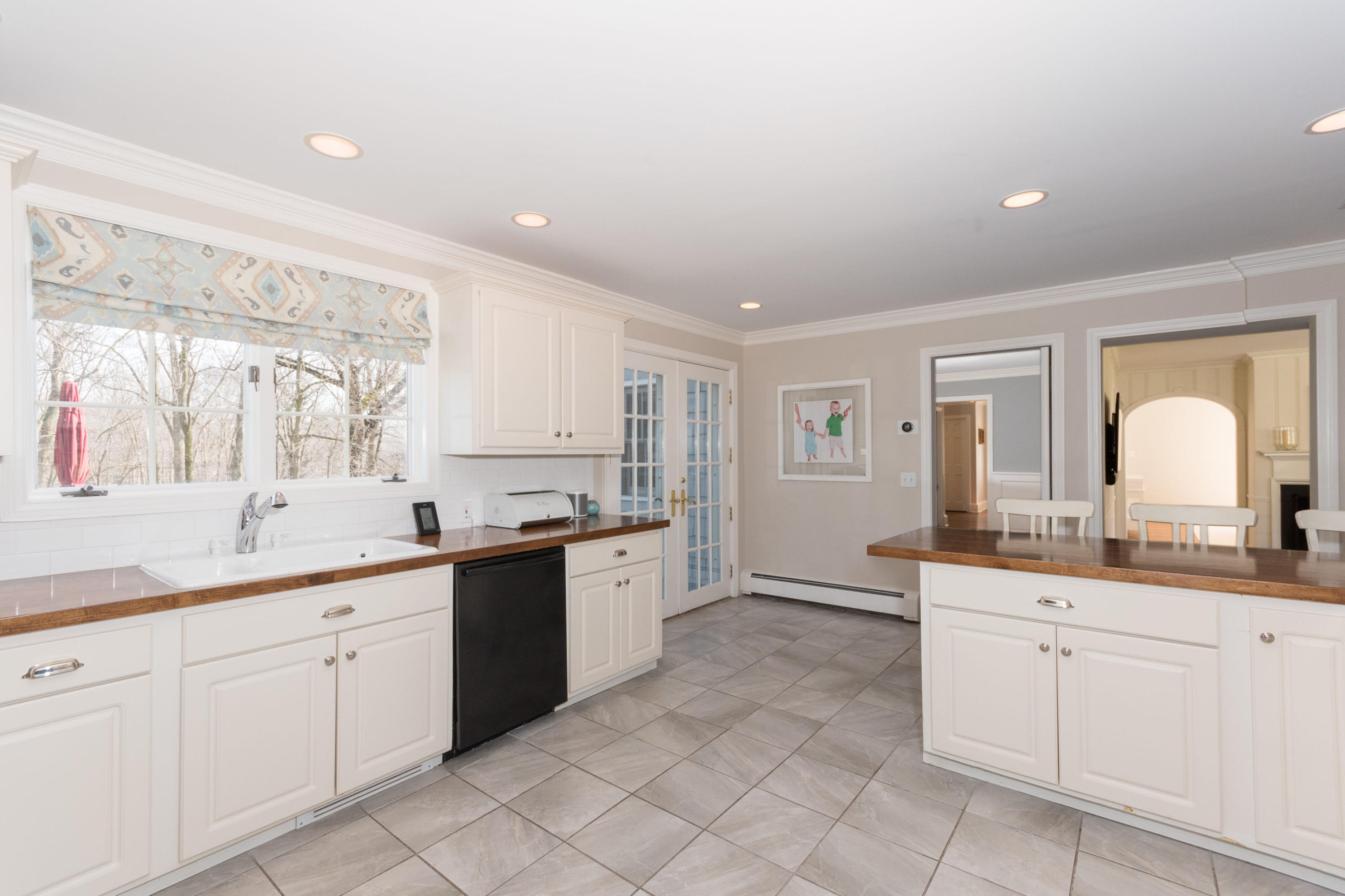 17 Point O Woods Road Darien, CT 06820 - Photo 16 of 44 a large white kitchen with a lot of counter space and wooden floor