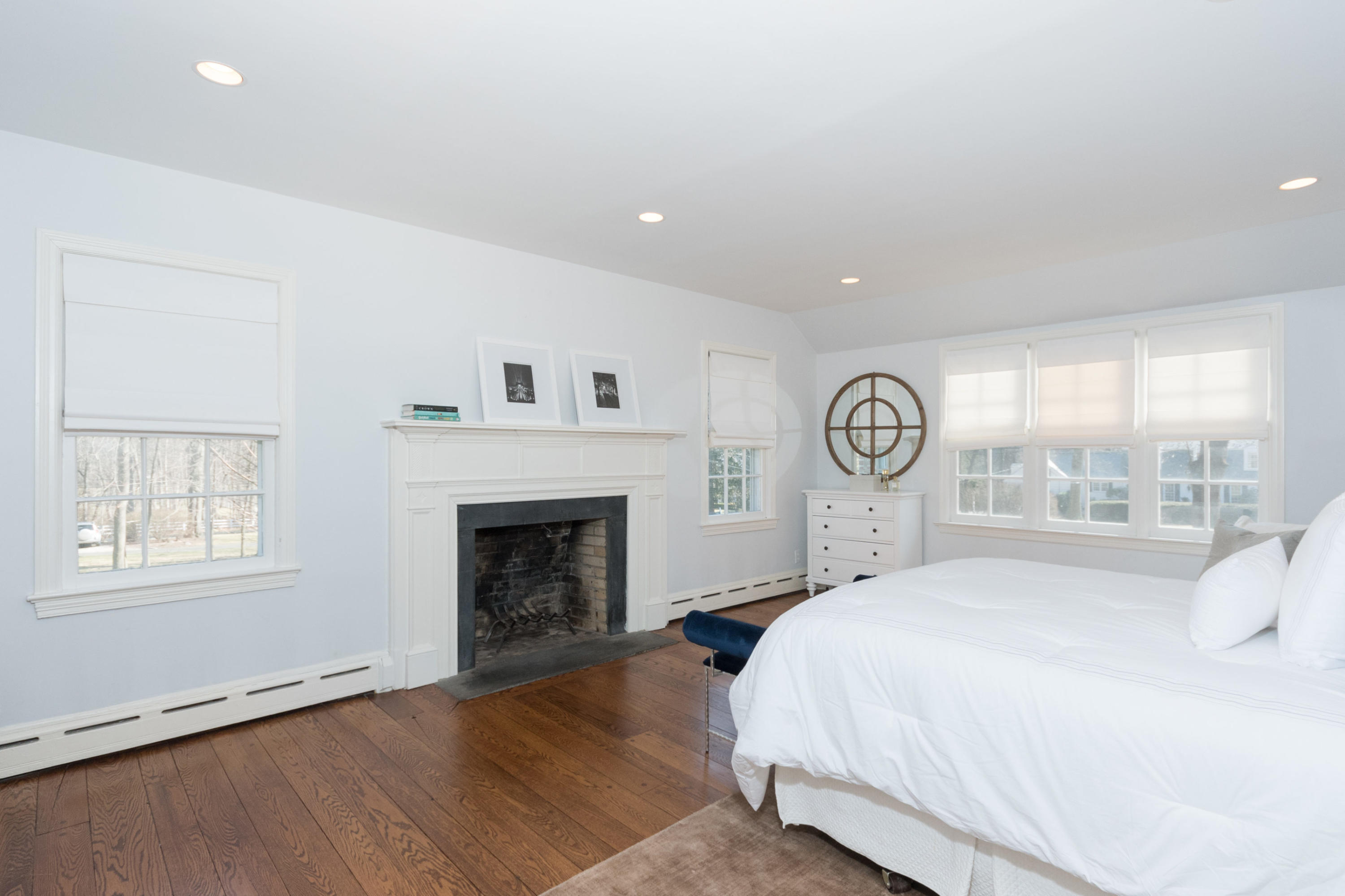 17 Point O Woods Road Darien, CT 06820 - Photo 21 of 44 a large bedroom with a bed and a fireplace