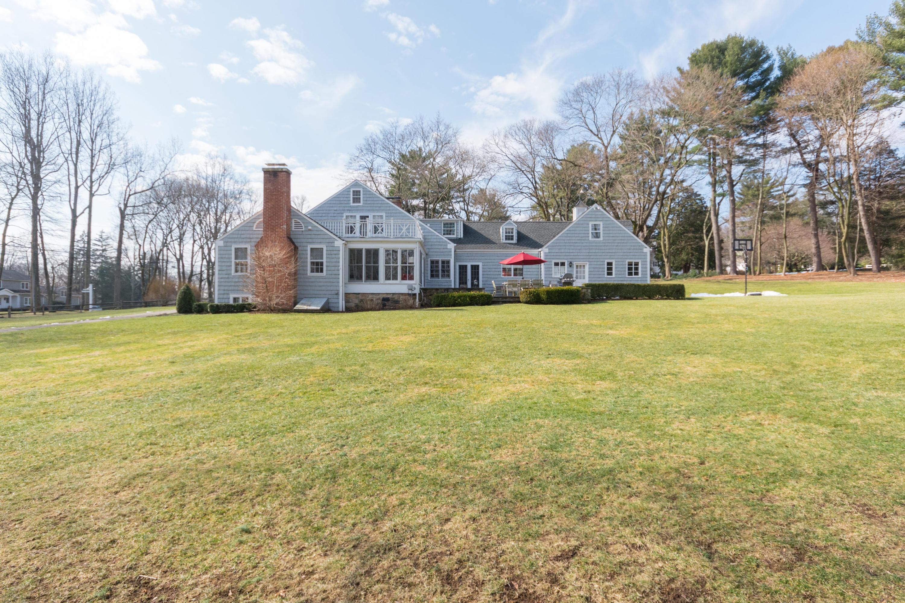 17 Point O Woods Road Darien, CT 06820 - Photo 41 of 44 a front view of a house with a yard and fountain