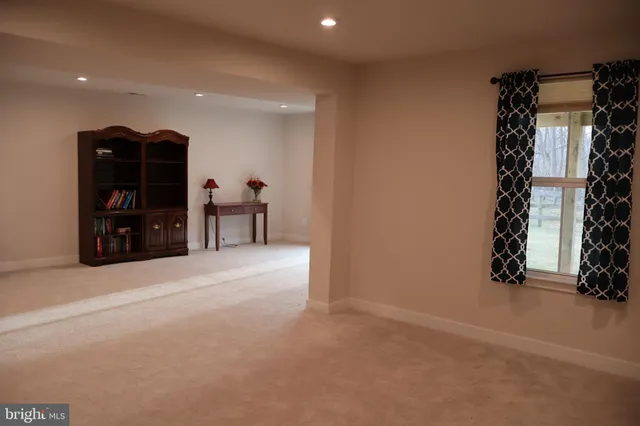 a view of a livingroom with furniture and staircase