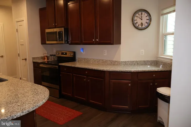 a kitchen with a sink a stove and a refrigerator