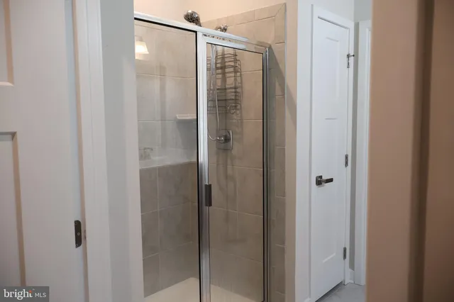a bathroom with a glass shower door