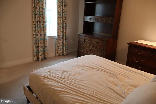 a bedroom with a bed and a television