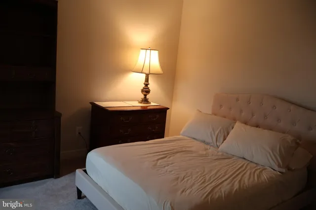 a bedroom with a bed and a lamp