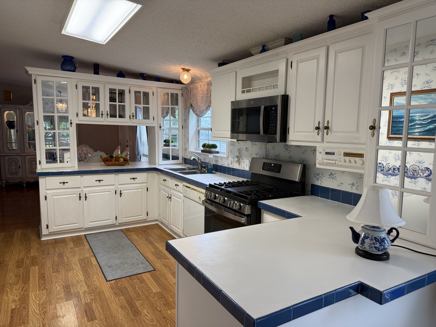 69 Petunia Circle Matteson, IL 60443 - Photo 2 of 25 a kitchen with stainless steel appliances a stove a sink and a microwave