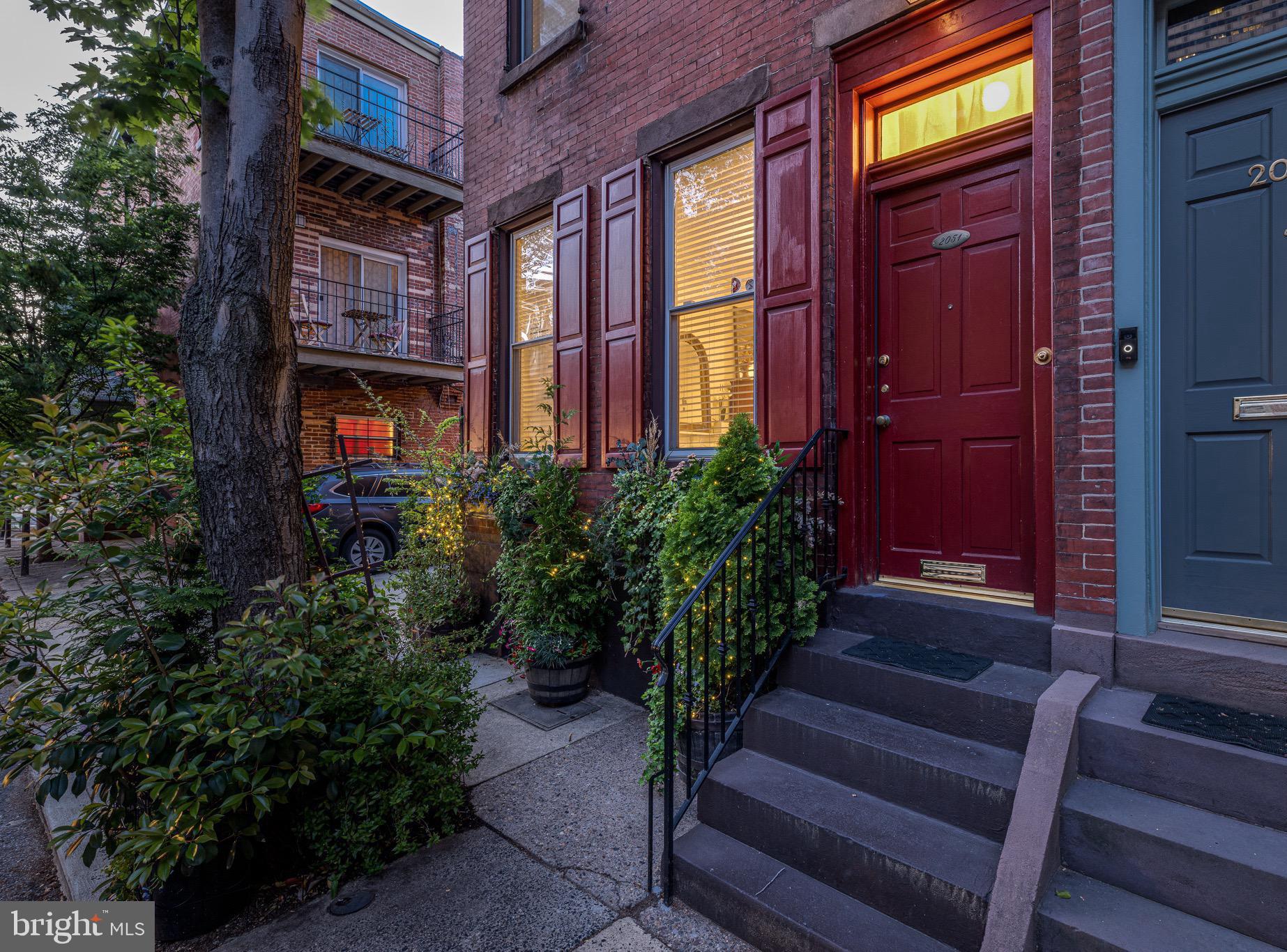 Solid brick exterior with lush planters