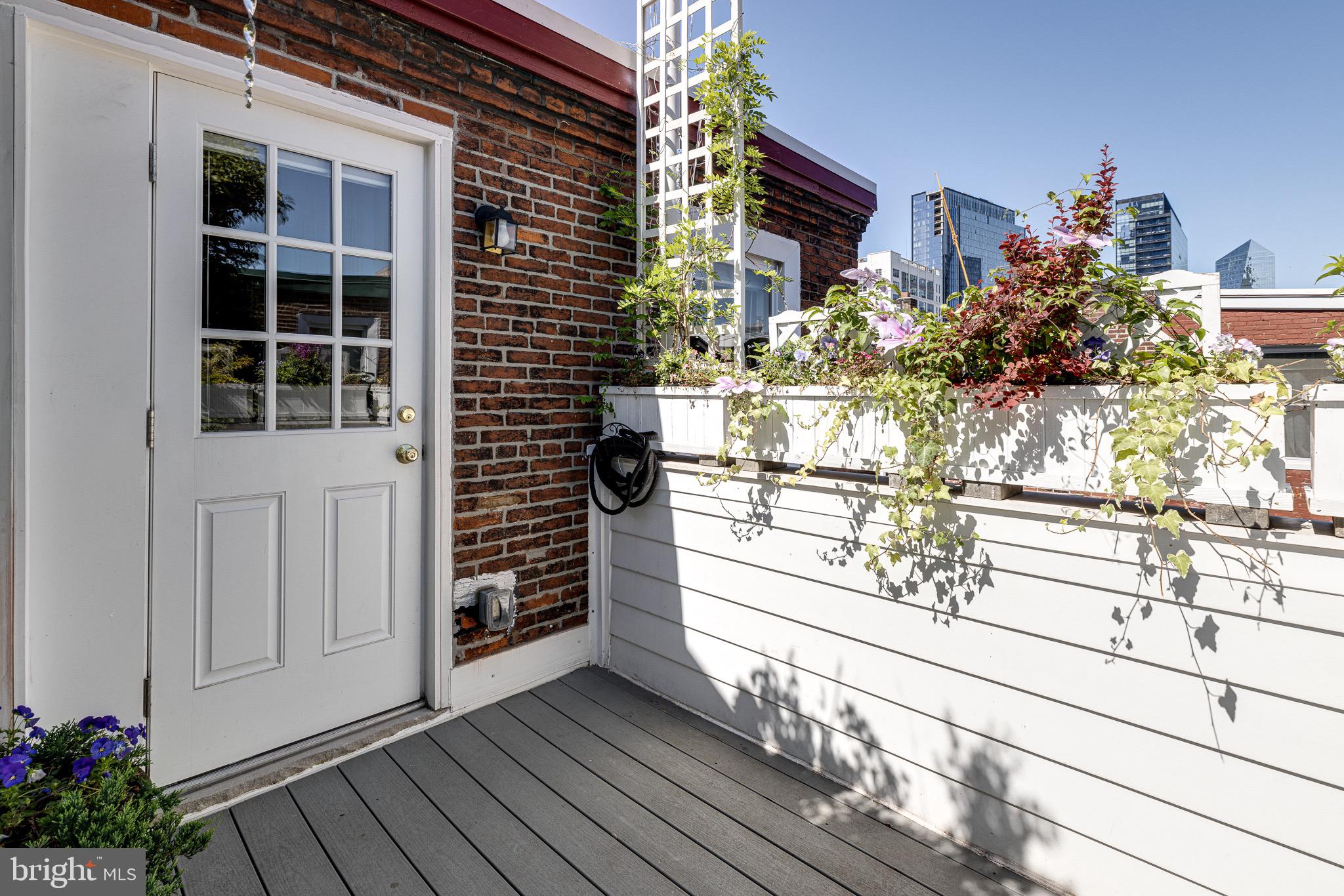 2051 Appletree Street Philadelphia, PA 19103 - Photo 30 of 36 Sunlit third-floor deck with flowering planters