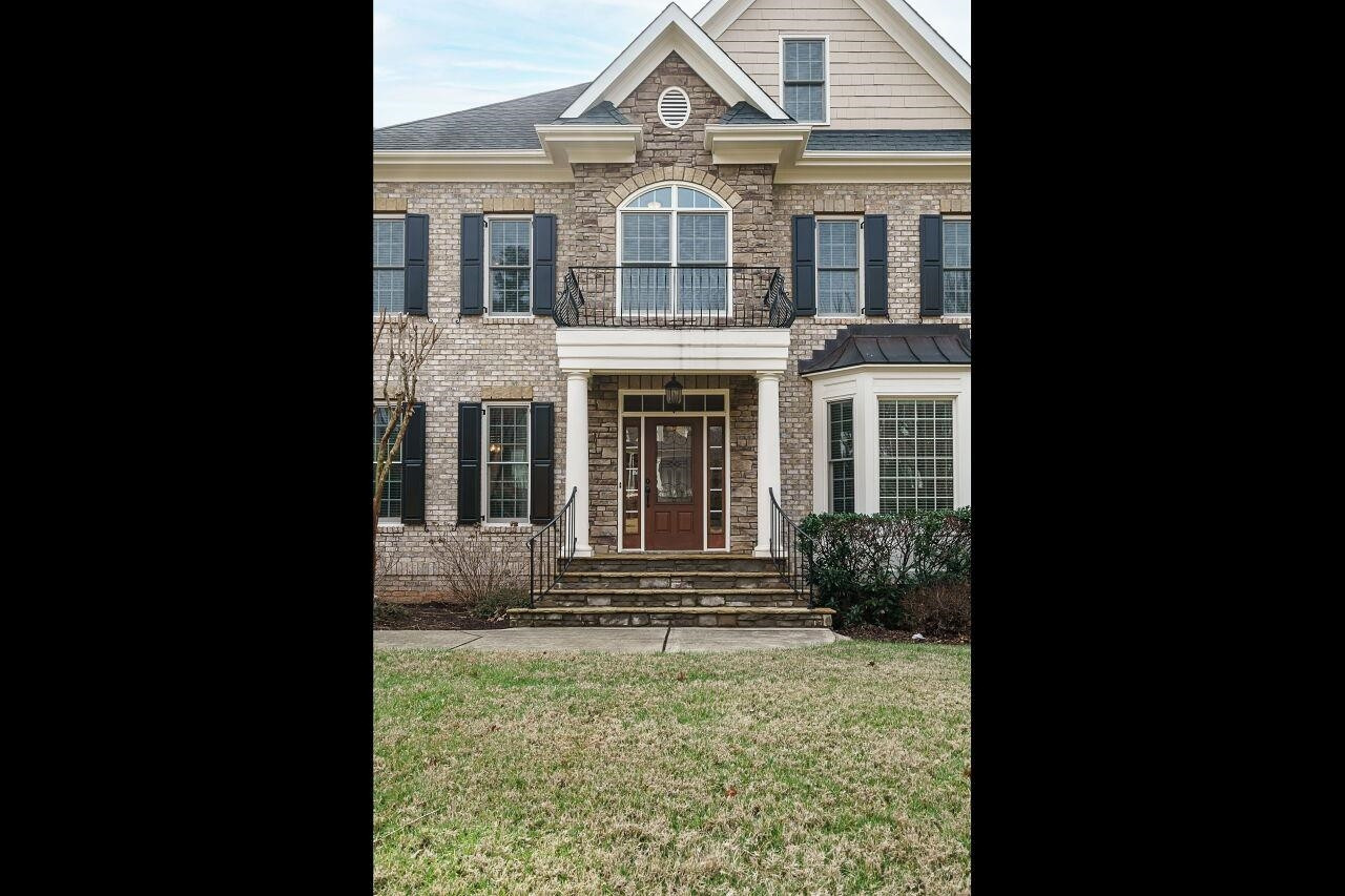 Covered front porch with brick and stone accents. Front Porch