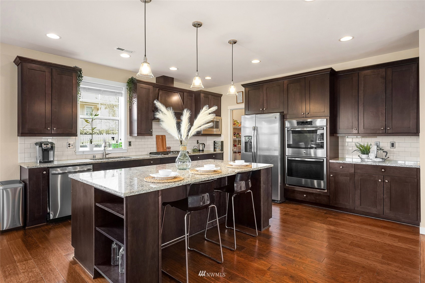 532 Ludwig Road Snohomish, WA 98290 - Photo 13 of 40 a kitchen with stainless steel appliances granite countertop wooden floors stove and cabinets