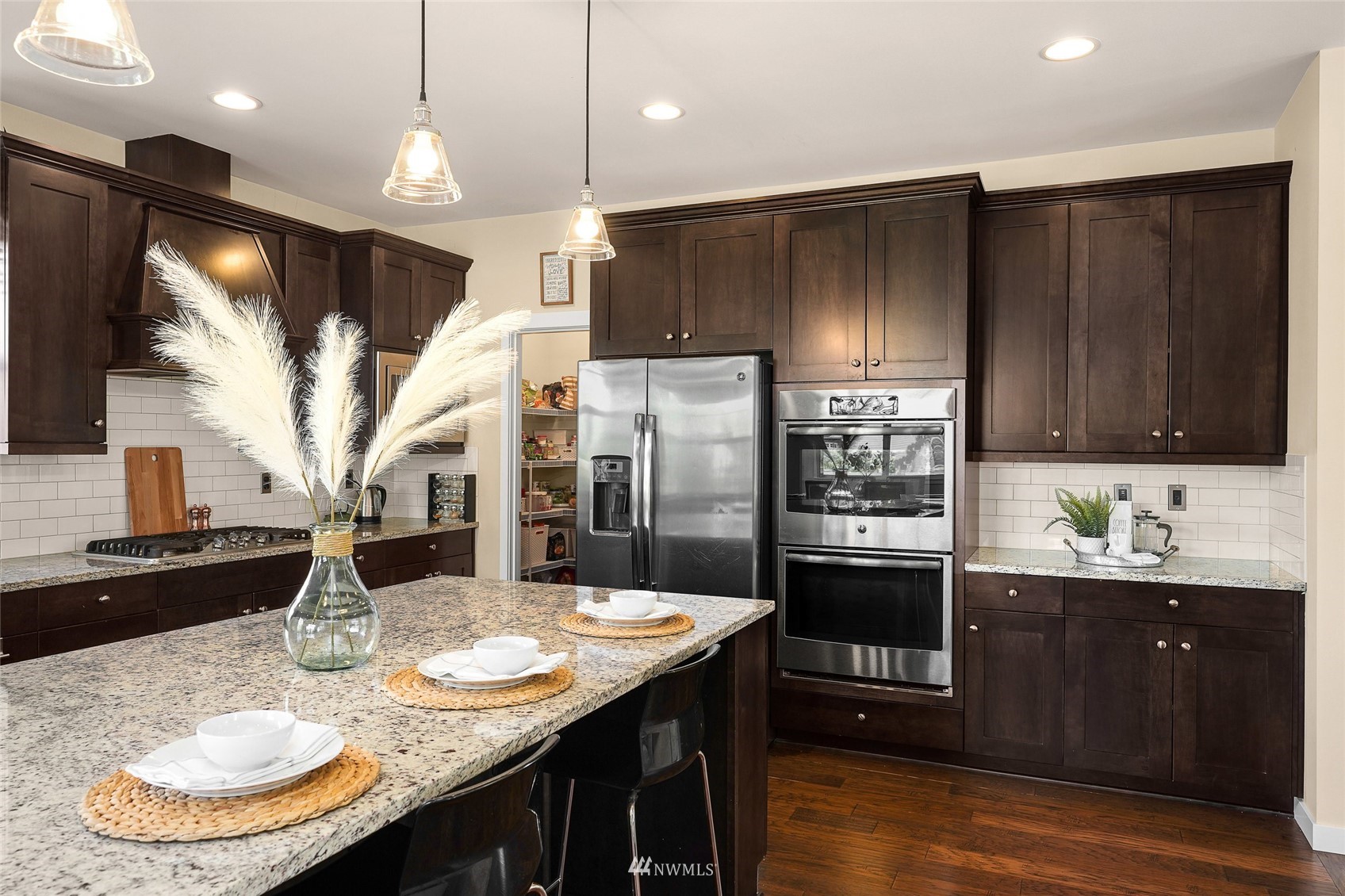 532 Ludwig Road Snohomish, WA 98290 - Photo 16 of 40 a kitchen with stainless steel appliances kitchen island granite countertop a sink refrigerator and cabinets