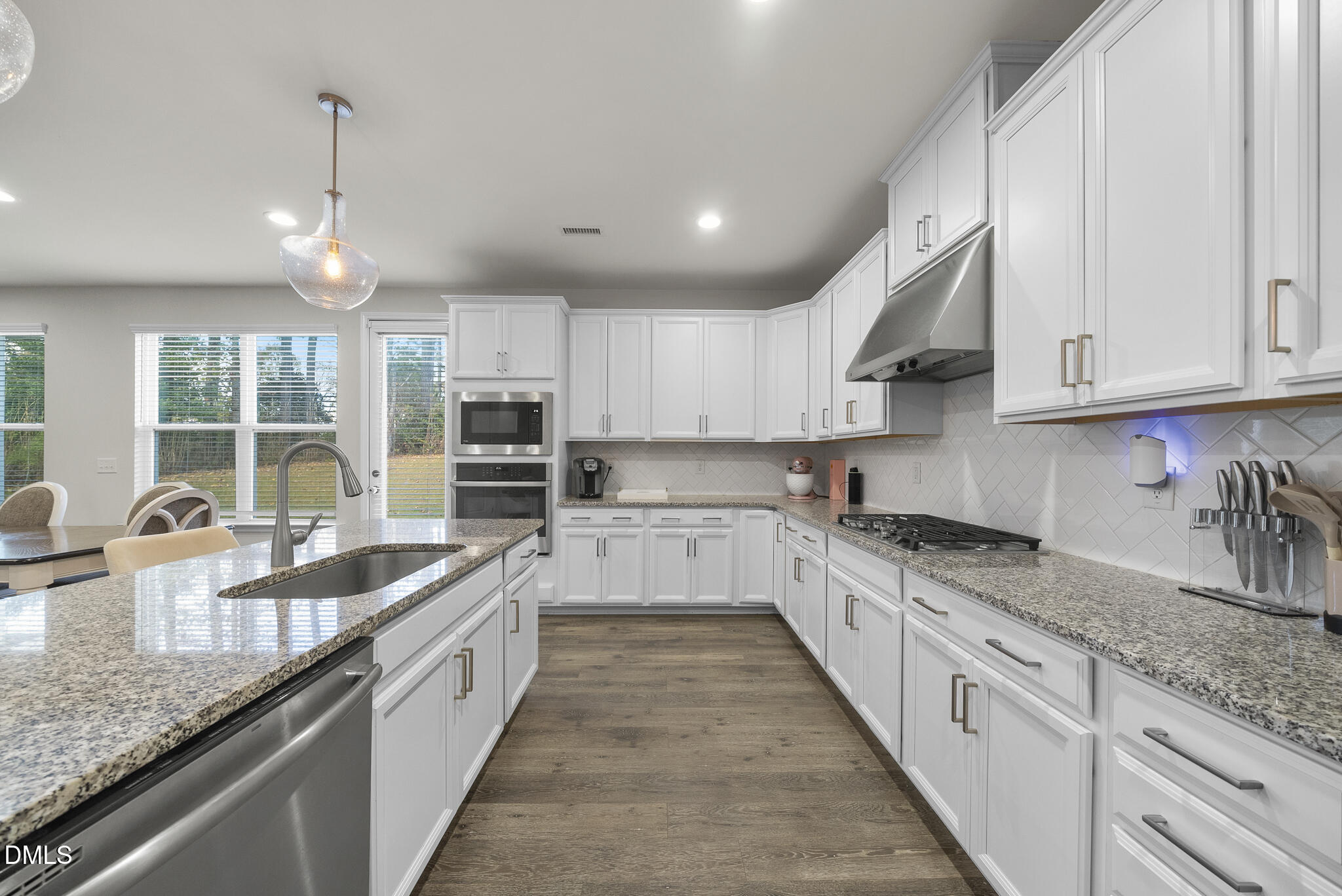 672 Millers Mark Avenue Wake Forest, NC 27587 - Photo 10 of 41 a large kitchen with granite countertop lots of counter space sink and cabinets