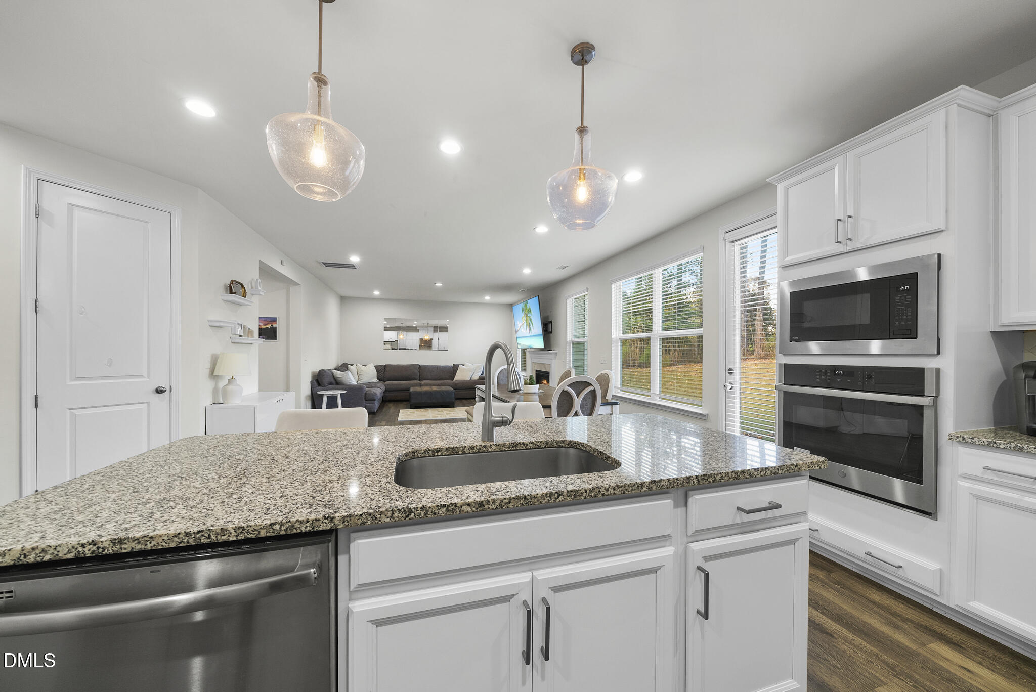 672 Millers Mark Avenue Wake Forest, NC 27587 - Photo 11 of 41 a kitchen with granite countertop stainless steel appliances a stove sink and microwave