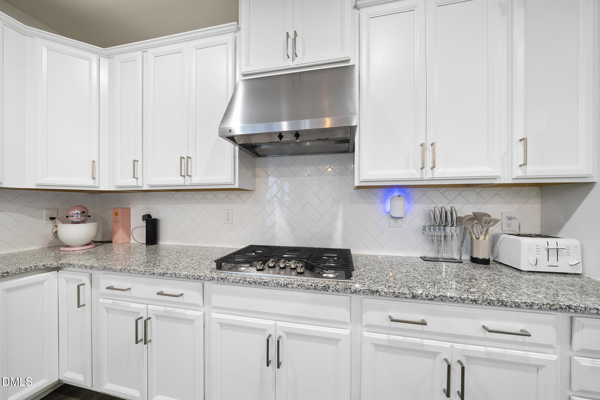 672 Millers Mark Avenue Wake Forest, NC 27587 - Photo 12 of 41 a kitchen with granite countertop white cabinets and a stove