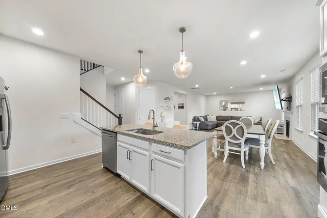 a kitchen with granite countertop white cabinets and a stove