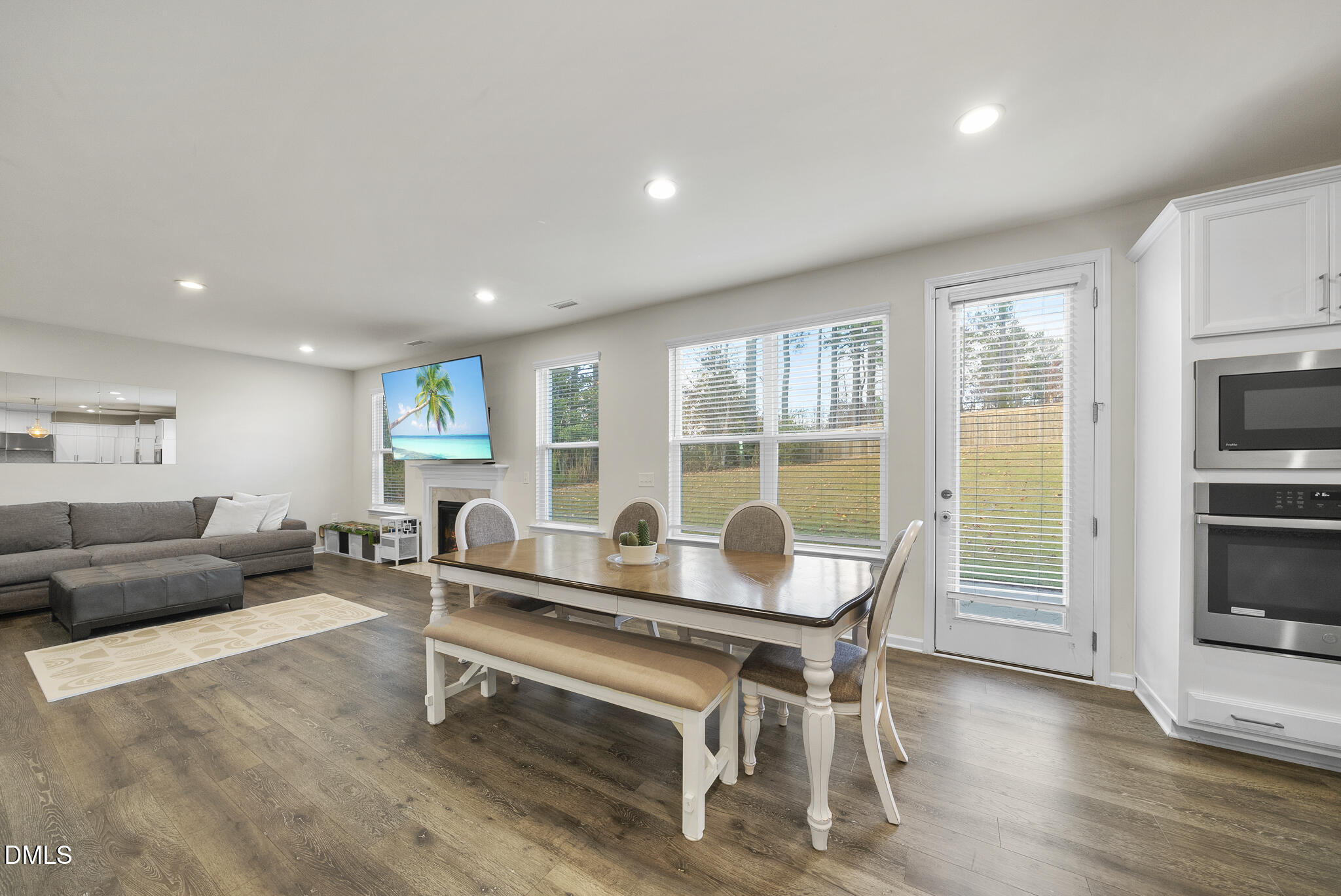672 Millers Mark Avenue Wake Forest, NC 27587 - Photo 14 of 41 a living room with furniture and a flat screen tv with kitchen view