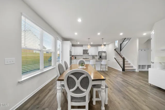 a living room with fireplace furniture and a wooden floor