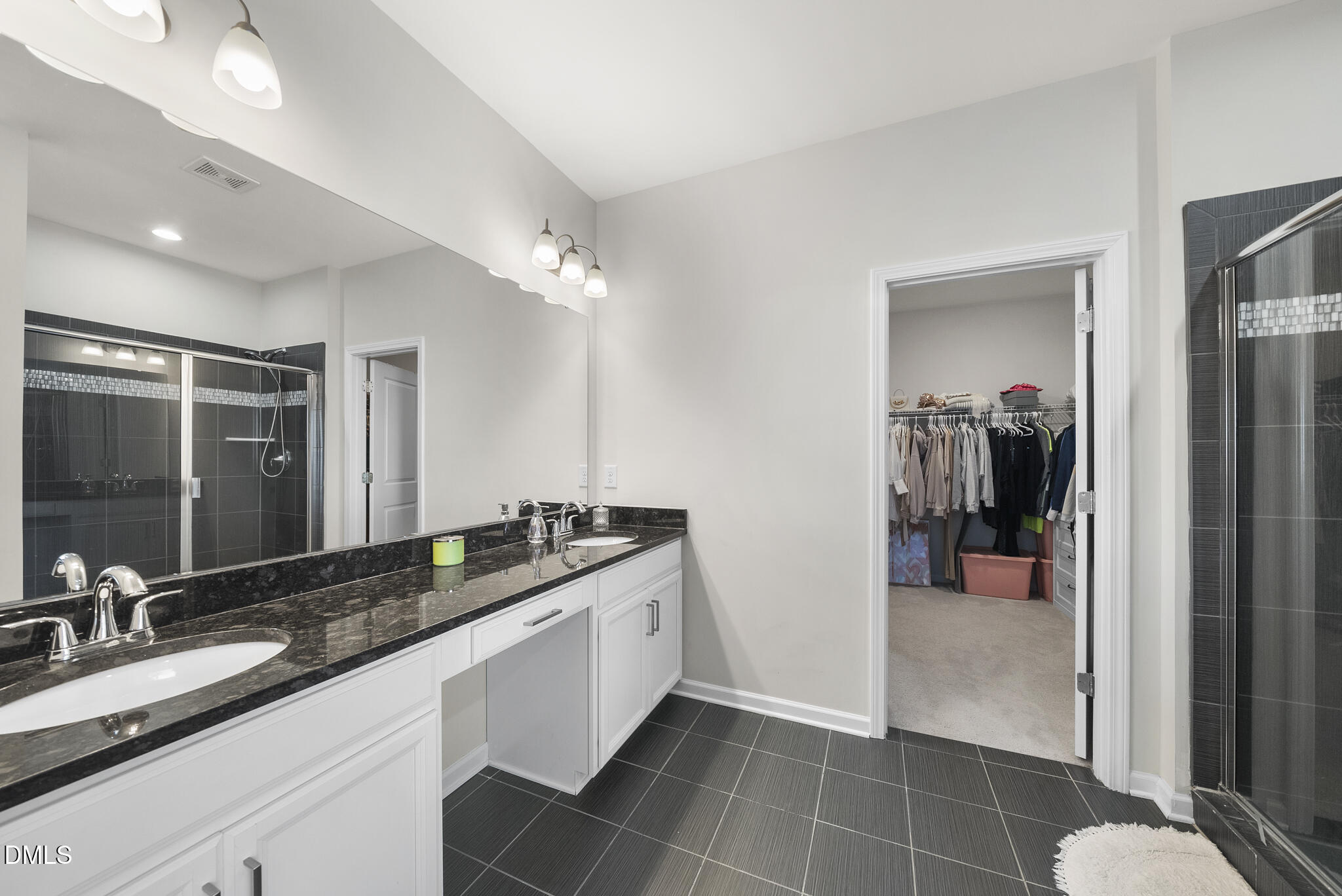 672 Millers Mark Avenue Wake Forest, NC 27587 - Photo 21 of 41 a bathroom with a double vanity sink a mirror and a shower