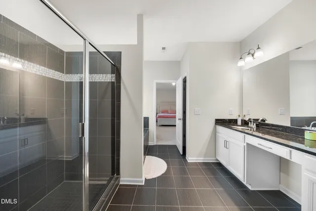 a bathroom with a double vanity sink a mirror and a shower
