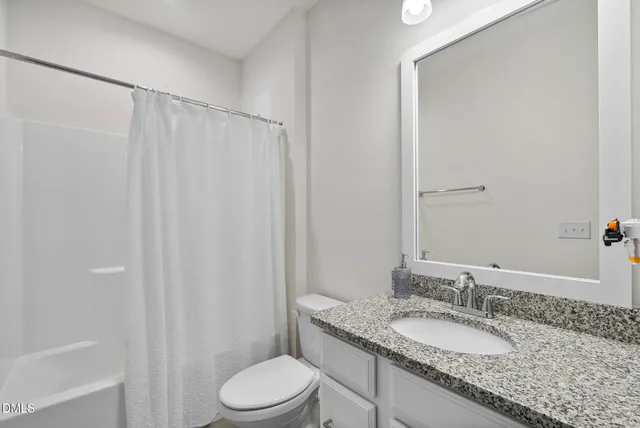 a bedroom with a bed and a desk