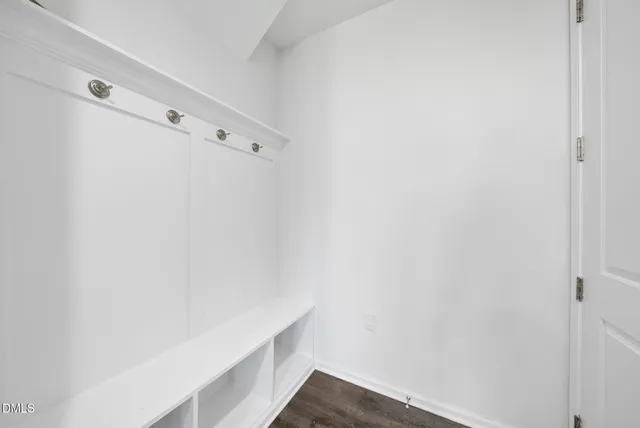 an empty room with furniture and a flat screen tv