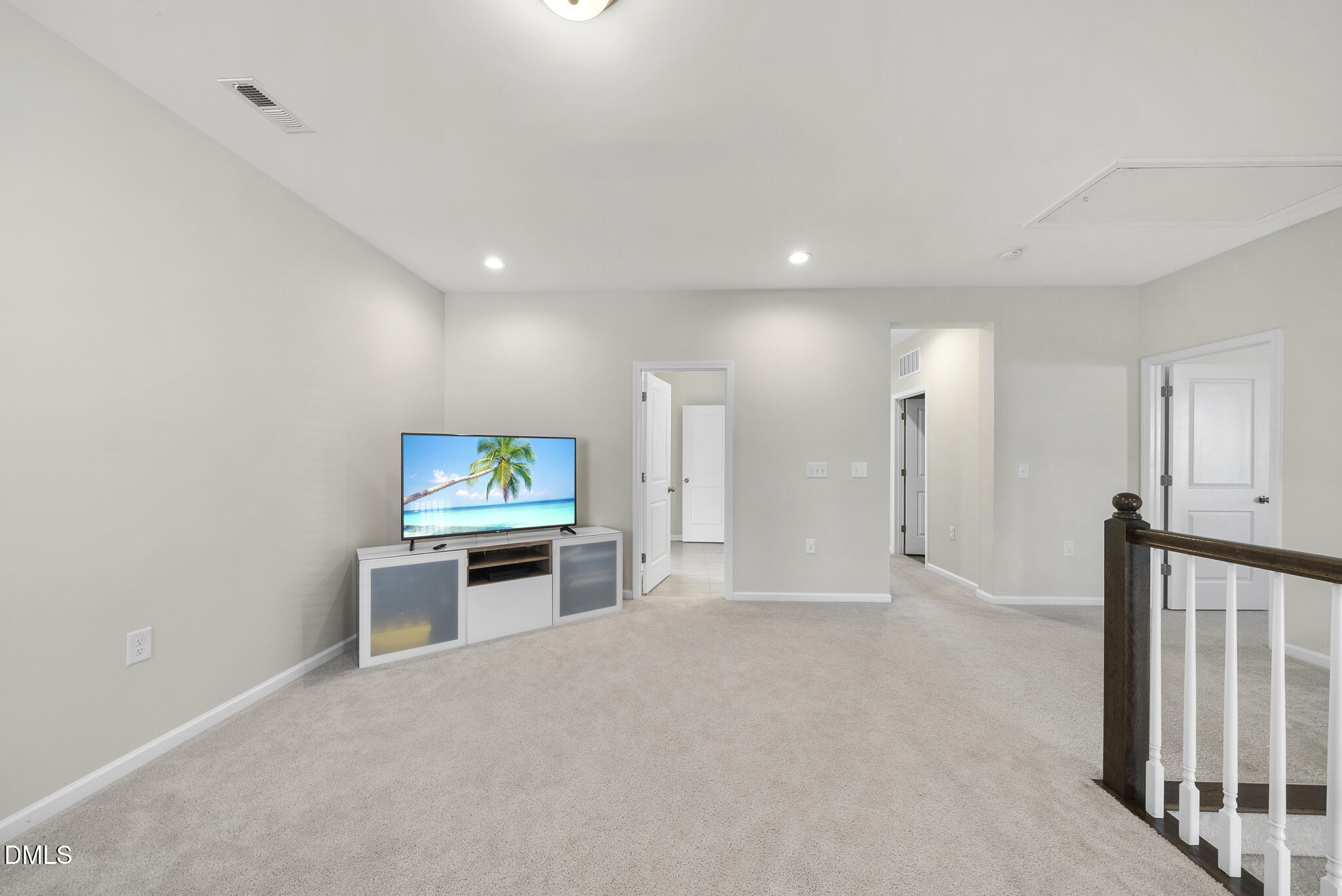 672 Millers Mark Avenue Wake Forest, NC 27587 - Photo 34 of 41 an empty room with furniture and a flat screen tv