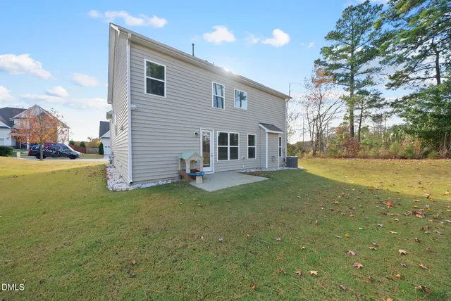 a view of a house with pool and a yard