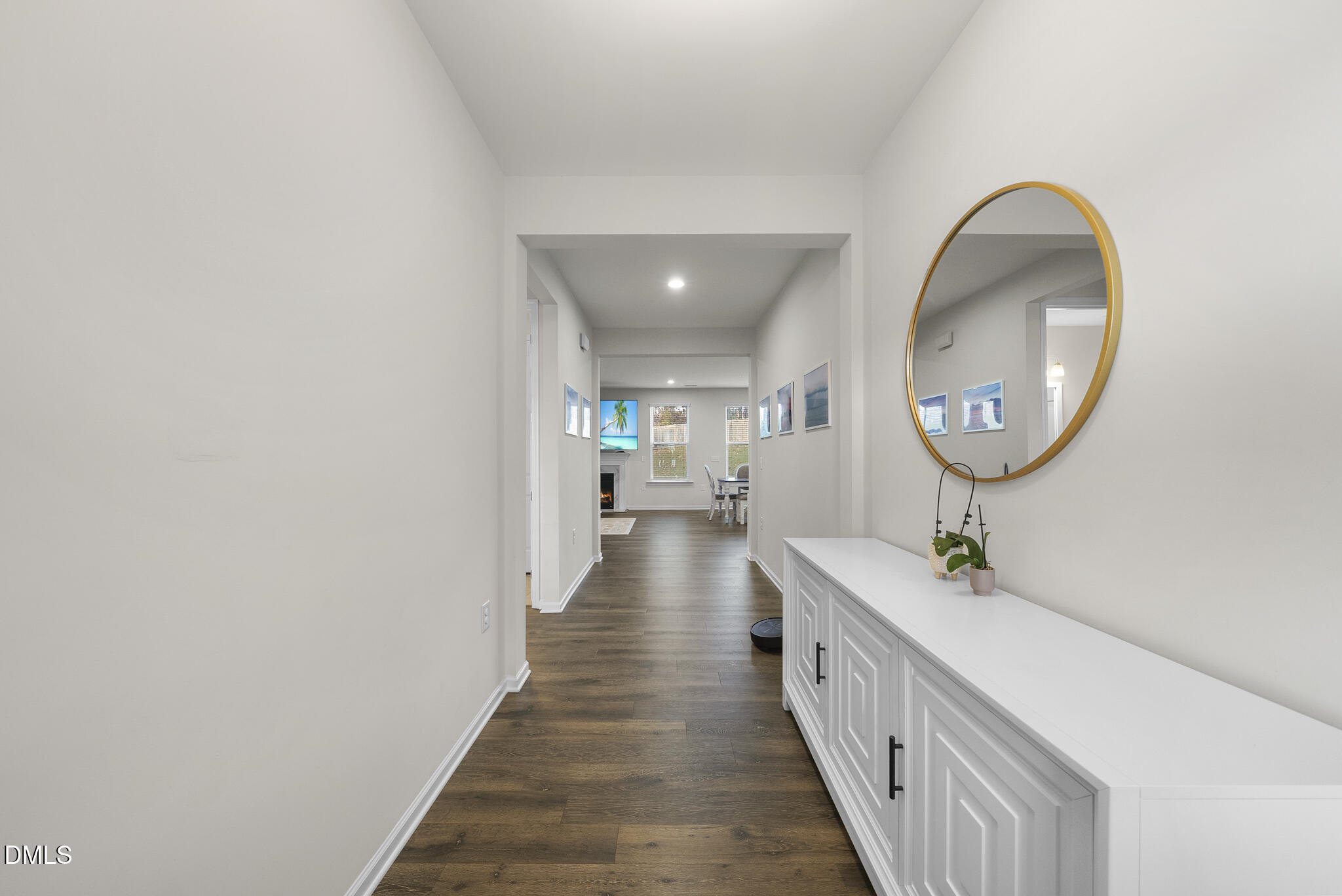 672 Millers Mark Avenue Wake Forest, NC 27587 - Photo 4 of 41 a hallway with a large mirror and a sink