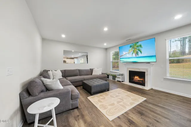 a hallway with a large mirror and a sink
