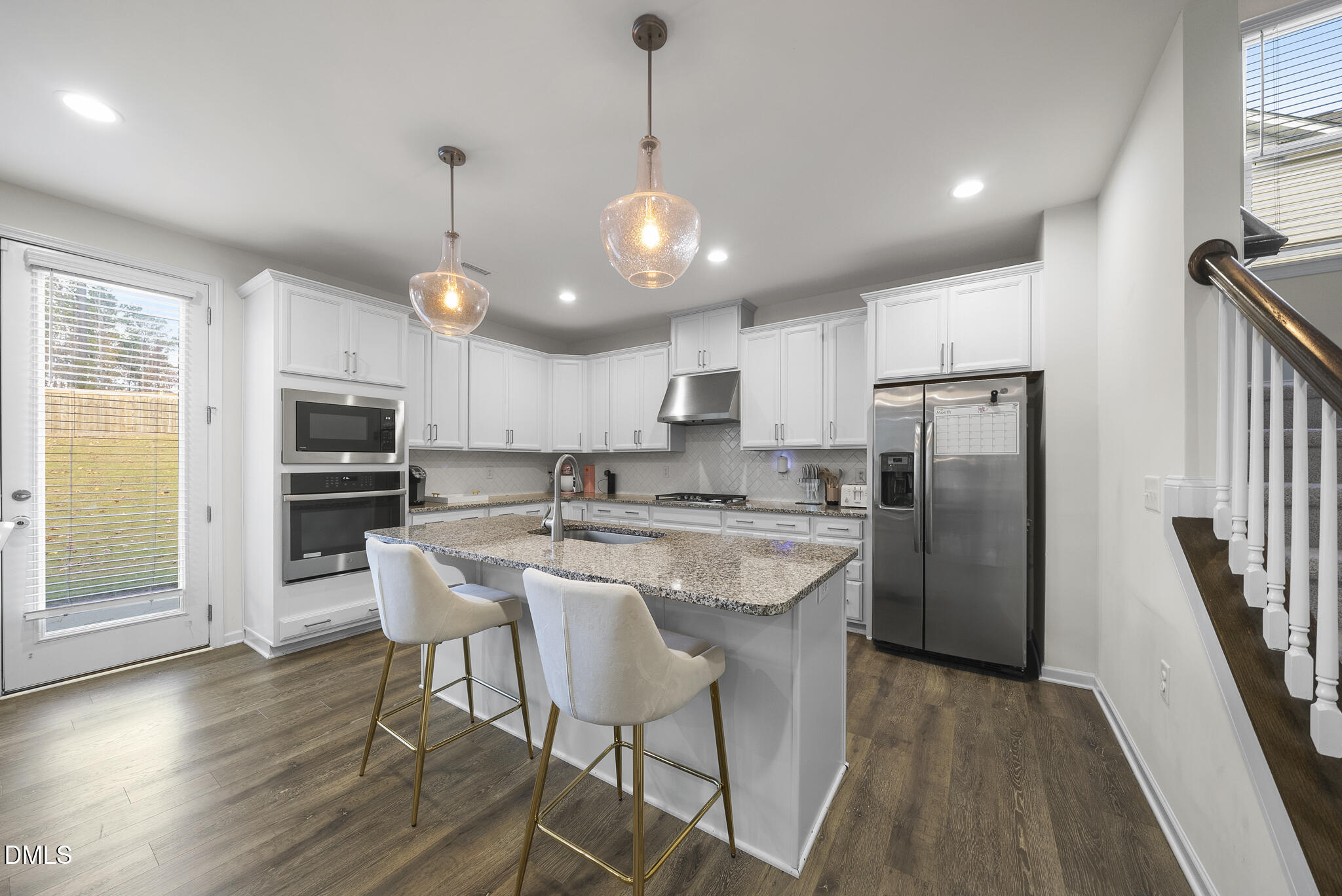 672 Millers Mark Avenue Wake Forest, NC 27587 - Photo 8 of 41 a kitchen with stainless steel appliances a dining table chairs refrigerator and microwave