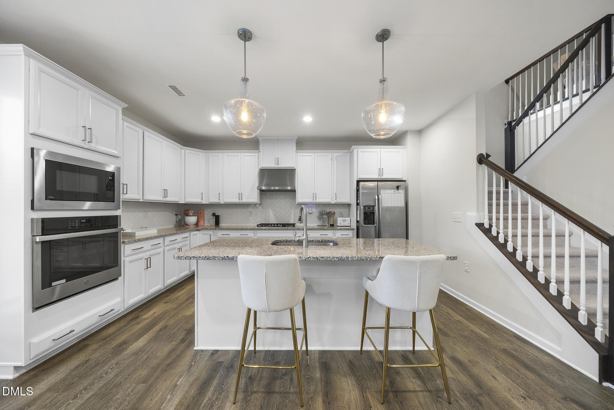 672 Millers Mark Avenue Wake Forest, NC 27587 - Photo 9 of 41 a kitchen with stainless steel appliances granite countertop a dining table chairs sink and cabinets
