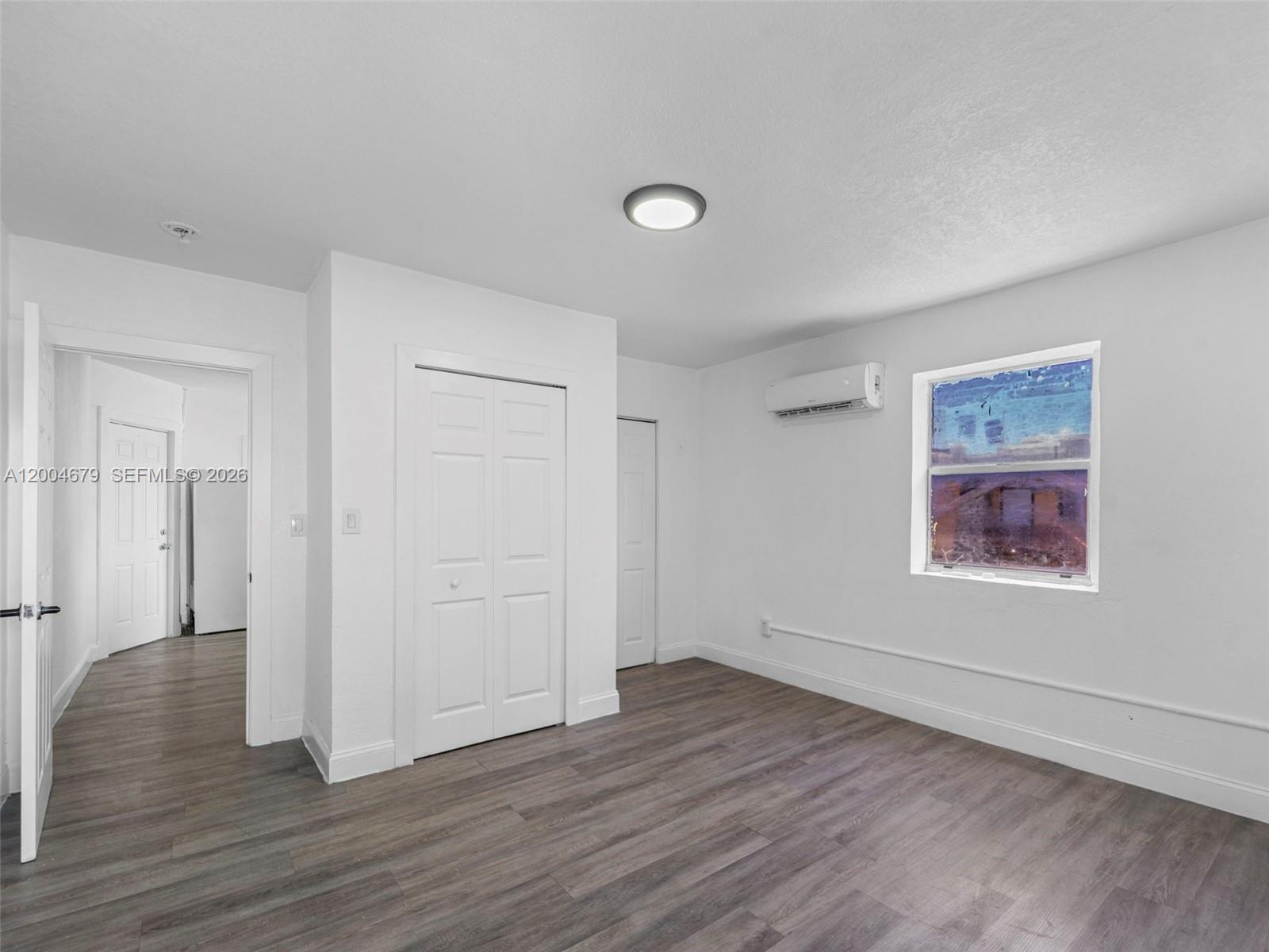 500 Southwest 8th Street Miami, FL 33130 - Photo 11 of 33 an empty room with wooden floor and windows