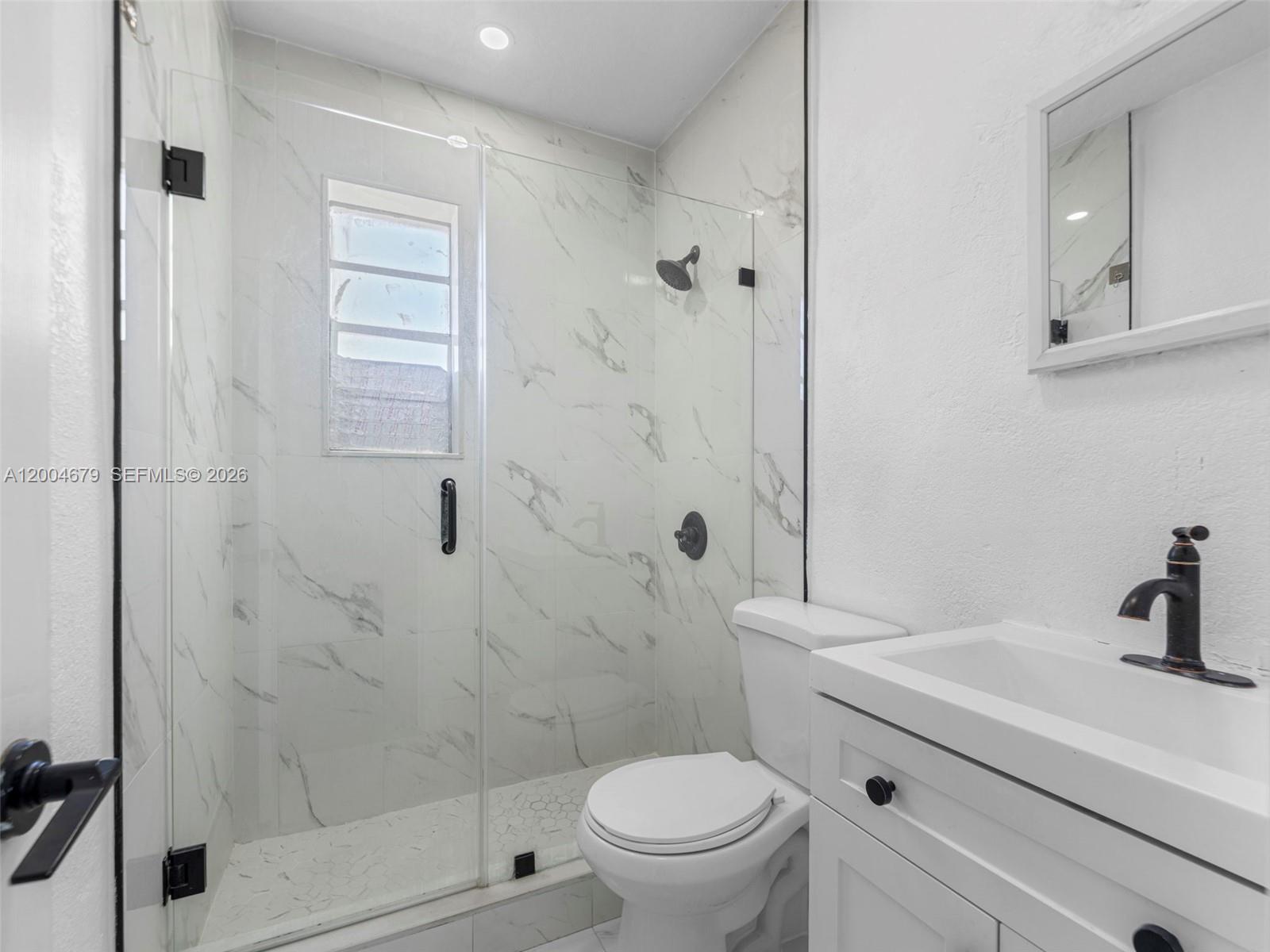 500 Southwest 8th Street Miami, FL 33130 - Photo 17 of 33 a bathroom with a sink a toilet and shower