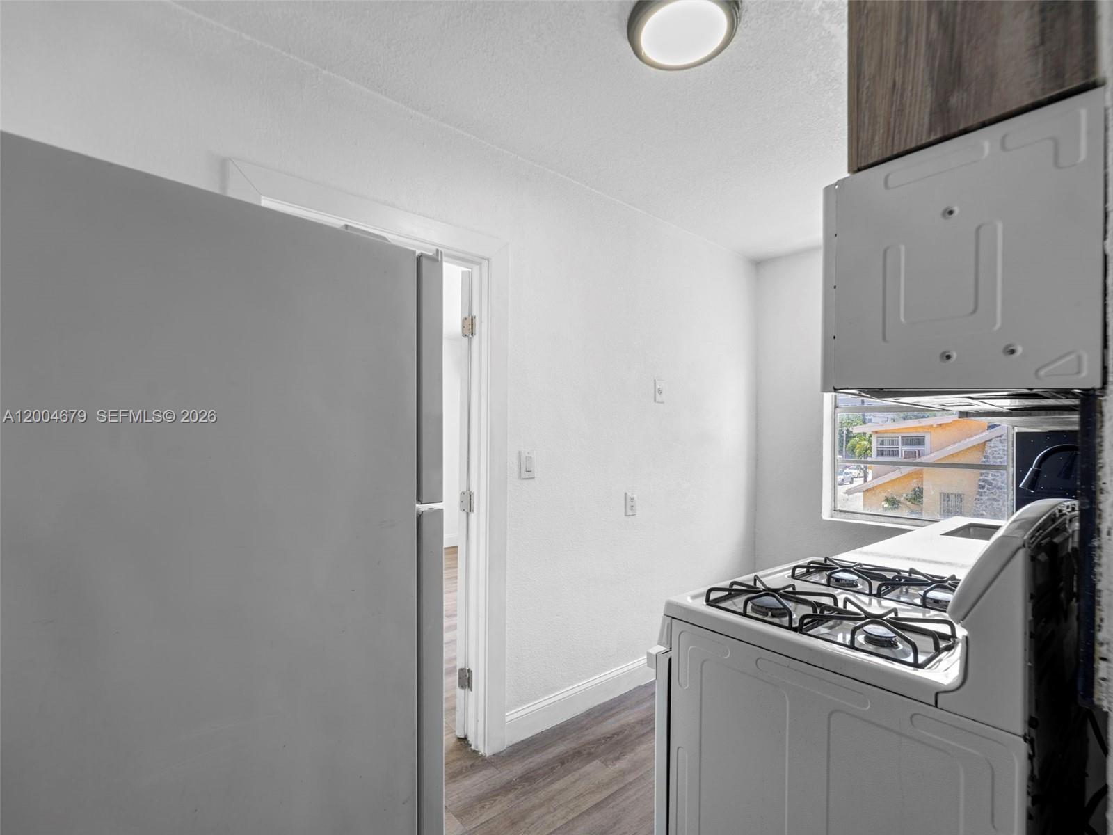 500 Southwest 8th Street Miami, FL 33130 - Photo 18 of 33 a kitchen with a stove and a refrigerator